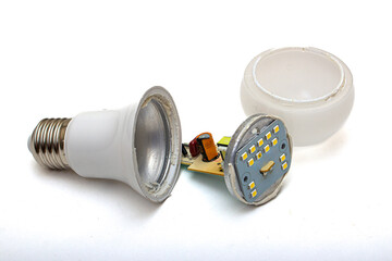 A broken LED light bulb, disassembled, on a white isolated background