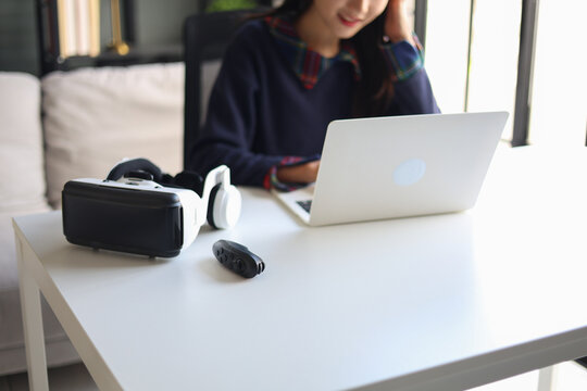 Women working with laptop and VR headsets.