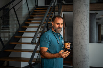 Doctor taking coffee break checking smartphone