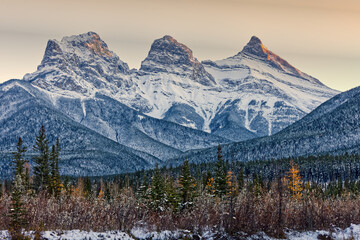 Three sisters with forest below
