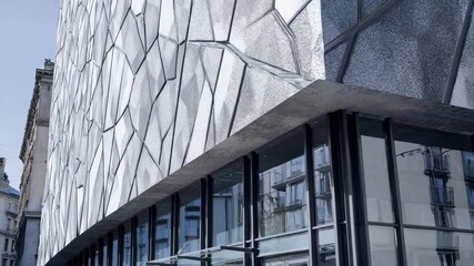 Closeup medium shot of a building facade applying a selfhealing membrane demonstrating innovative technology that repairs surface damage automatically.