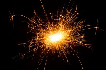 Bright sparkler emitting vibrant golden sparks against a dark background, creating a festive atmosphere, ideal for celebrations and special occasions, symbolizing joy and excitement