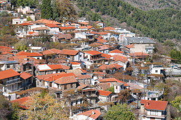 Picturesque mountain village with traditional red tile roofs in cyprus showing residential homes