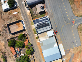 Small red plane in front of the hangars