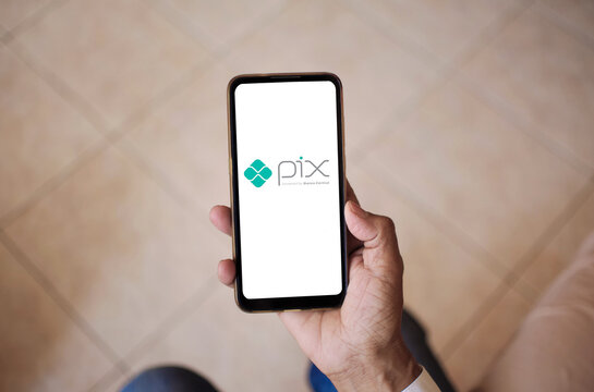 Pix app logo at smartphone screen. Brazilian instant payment. The payment method created by the Central Bank in which funds are transferred between accounts in seconds