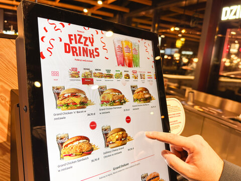 09.12.2024, Jastrzębie-Zdr&oacute;j, Poland: Customer using a Max Burgers self-order kiosk inside a modern fast-food restaurant