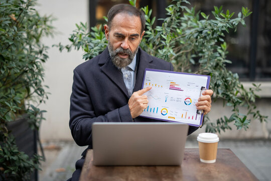 Senior businessman presenting market data on video call