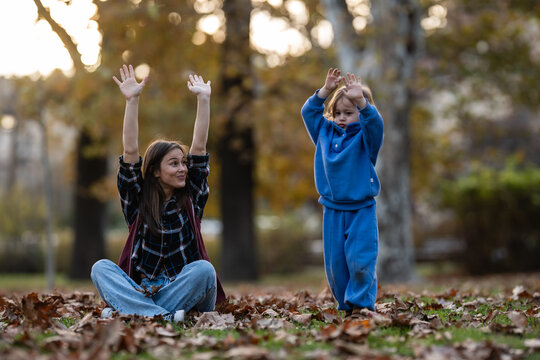 Mother and child playing in autumn park