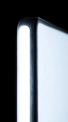 Illuminated Screen Abstract: Close-up of a luminous screen against a dark backdrop, emphasizing sleek design and a sense of modern technology.