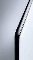 Minimalist Modern Design: A sleek, close-up shot focuses on a polished black, curved, object against a soft gradient background, embodying sophistication and minimalist design.