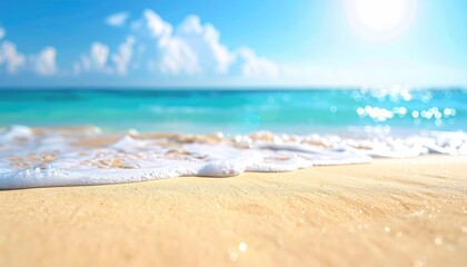Foamy waves gently lap onto a light sand beach under a sunny blue sky with fluffy white clouds above a turquoise ocean