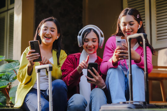Diverse young women travel together, embracing technology with s