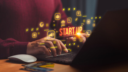 Person using laptop computer with startup icon, digital marketing, communication, bank, and innovation symbols, representing business growth, entrepreneurship and technology-driven solution.