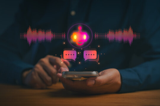 Voice chatbot technology concept, person using smartphone with glowing AI bot, sound wave, chat icon, symbolizing voice assistant, automated messaging, smart communication, and digital interaction. - Powered by Adobe