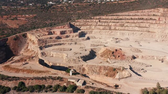 aerial bench levels close-up reveal spoil piles, terraced cut lines, sampling points and access ramps, detailed geology perspective with exposed strata and working pits under clear light