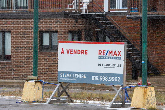 Canada, 07 November 2025 : Commercial property for sale sign outside brick building during snowfall