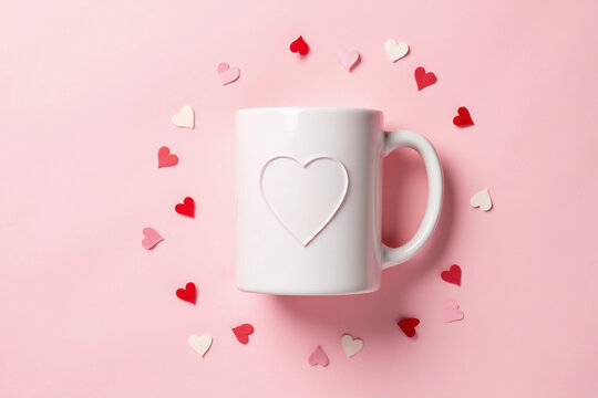 White mug mockup with heart shape confetti on pink background. Valentine's day mockup.