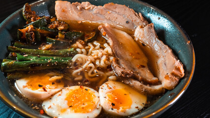 Delicious pork belly ramen with fresh asparagus, zucchini, and Nissin noodles. Rich broth, perfect comfort food. Quick and flavorful meal for Asian cuisine lovers.