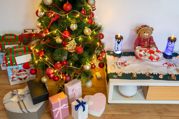 Christmas tree decorated with festive ornaments and gifts