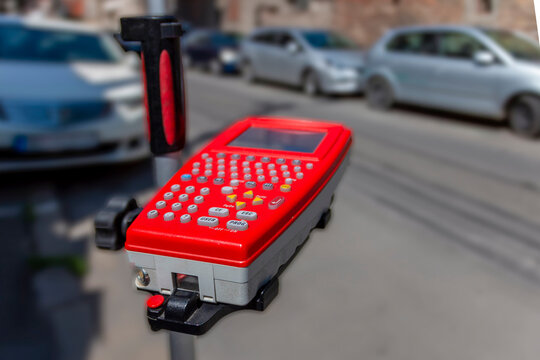 Handheld electronic device collecting data on city street - Powered by Adobe