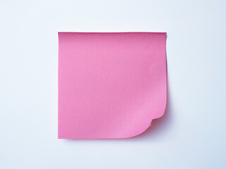 Single pink sticky note with curled corner placed on a clean white background. 