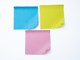 Three colorful sticky notes—blue, yellow, and pink—arranged on a white background.