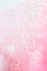 Soft pastel pink soap bubble texture. Cosmetics texture macro.Pink bubbles of soap foam 