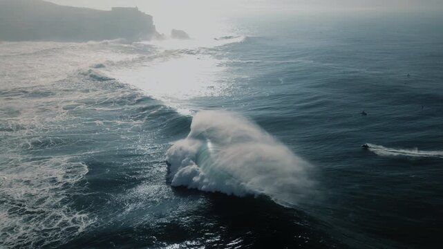Surfers ride massive waves at Nazare Portugal's breathtaking sea