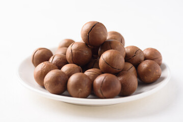 Fresh organic macadamia nuts on white background