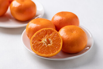 Mandarin orange fruit on white plate with white background