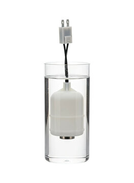 Float switch sensor in glass of water with power plug detects liquid level