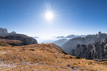Extraordinary natural epic landscape on a sunny day of summer. Dolomites mountains in Italy, Europe. Landscape with mountain and sun.