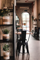 Cozy Cafe Interior A Serene Space with Plants, Tables, and Chairs for Relaxation and Coffee