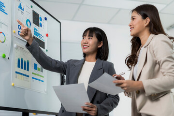 Businesswomen analyzing data charts during office meeting