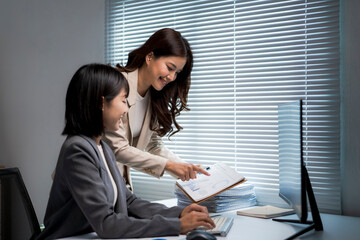 Businesswomen collaborating in office, working on project together