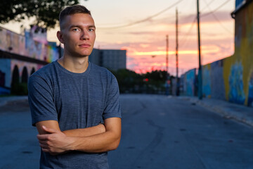 Handsome young man in a downtown urban setting at sunset
