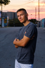 Handsome young man in a downtown urban setting at sunset