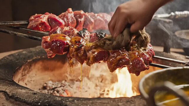 Tandoori chicken cooking in traditional indian clay oven with flames