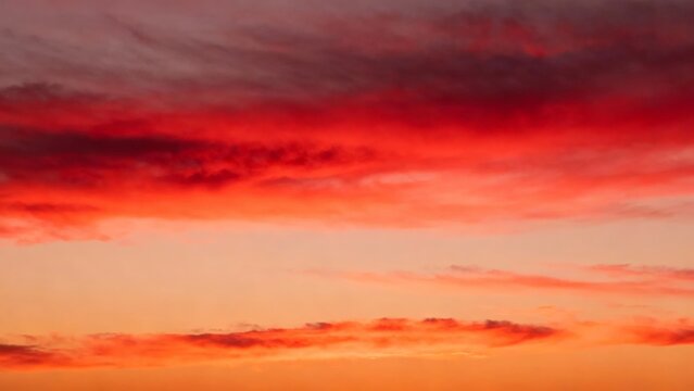 Vivid red and orange sky at sunset with scattered clouds - Powered by Adobe