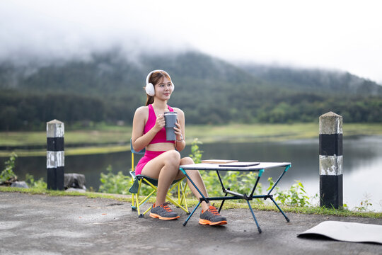 Woman relaxing outdoors with coffee, listening to music