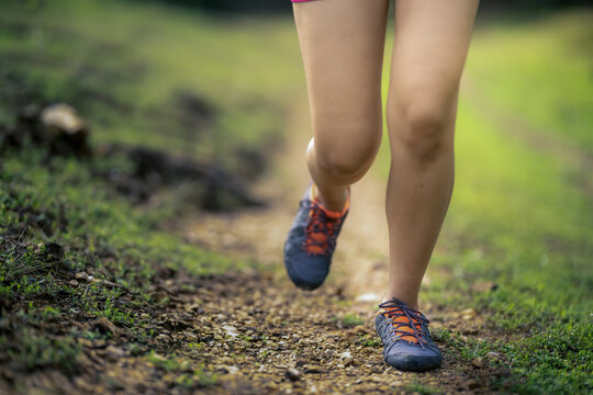 Woman trail running outdoors for fitness exercise