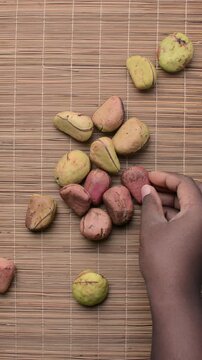 Overhead view of kola nut on rattan mat, top view of kolanut seed