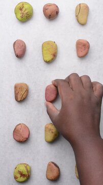 Overhead view of open kola nut on white granite countertop, top view of fresh kolanut