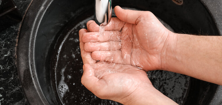 Man washing hands with soap in black sink, closeup - Powered by Adobe