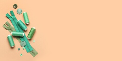 Set of sewing accessories on beige background with space for text