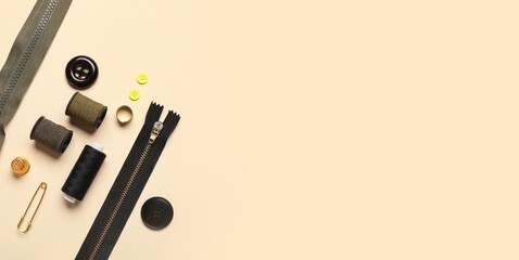 Set of sewing accessories on beige background with space for text