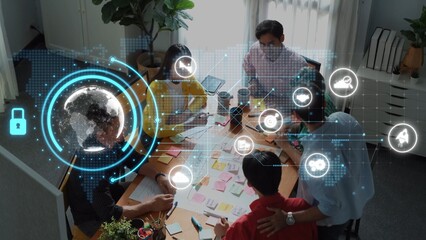 A diverse team gathers in a modern office to brainstorm ideas, utilizing technology and digital elements, showcasing creativity and collaboration in an innovative environment. Raster