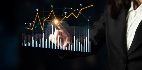 A business professional interacts with an advanced digital financial graph, analyzing vital trends...