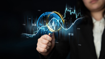 A business professional uses a magnifying glass to analyze financial data and economic trends, highlighting the importance of analysis in today global economy. Scalp