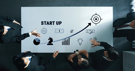 A dynamic meeting scene showcasing business professionals engaging in discussions about startup...